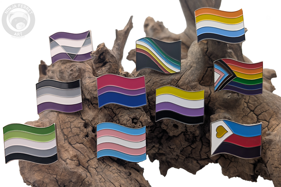 Pride flag enamel pins on driftwood – Ninja Ferret Art