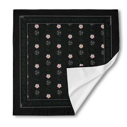 The 'Kinky' (black) silk bandana shown as a flat square, with the bottom-right corner peeled up to show the white, unprinted reverse side of the fabric.